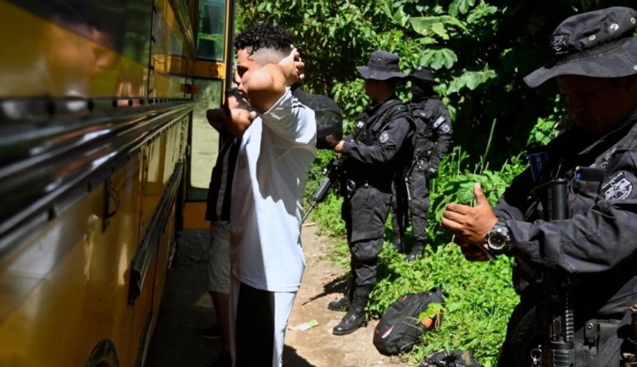 Young men are taken off a bus by police