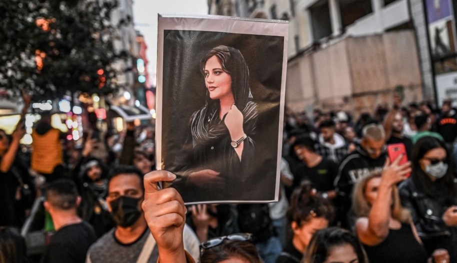 A protester holds a portrait of Mahsa Amini during a demonstration in Turkey in support of Amini, a young Iranian woman who died after being arrested in Tehran by the Islamic Republic's 'morality police.' (Photo by OZAN KOSE/AFP via Getty Images)