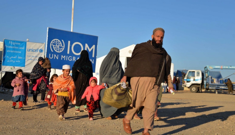Afghan refugees walk at a registration centre, upon their arrival from Pakistan in Takhta Pul district of Kandahar province on December 18, 2023. Photo by SANAULLAH SEIAM/AFP via Getty Images.