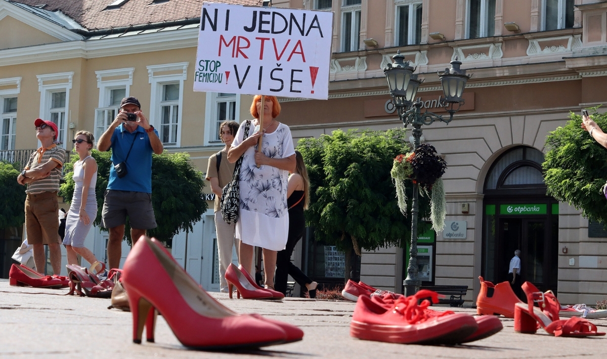 Protesters, holding banners, stage 'End domestic violence' demonstration as they display 24 pair of shoes to draw attention on the murder of women in Bosnia and Herzegovina on August 21, 2023 in Novi Sad, Serbia. (Photo by Aleksandar Savanovic/Anadolu Agency via Getty Images)