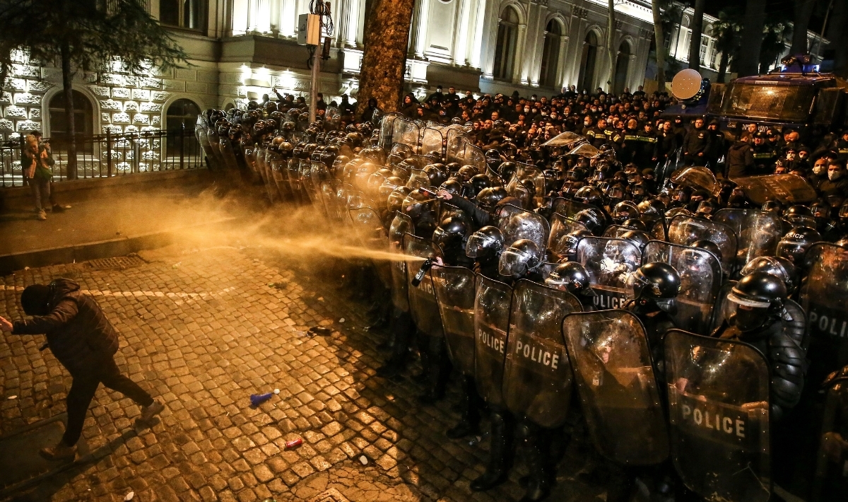 Georgian riot police spray tear gas and water canons at people as they form a cordon near the Georgian parliament in Tbilisi on March 7, 2023. Thousands of people took to the streets to oppose a controversial "foreign agents" bill. (Photo by AFP via Getty Images)