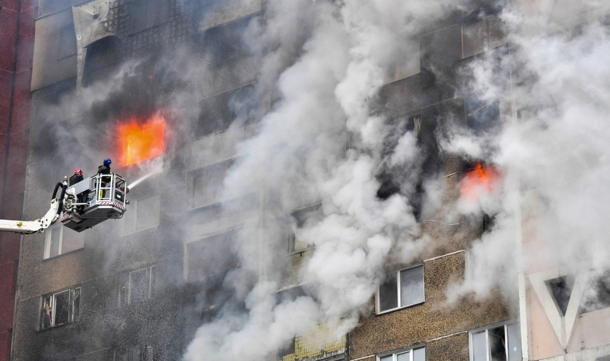 Ukrainian rescuers extinguish a fire in a residential building following a missile attack in Kyiv on February 7, 2024, amid the Russian invasion of Ukraine. At least three people were killed in a "massive" wave of Russian missile and drone attacks across Ukraine early on February 7, 2024, President Volodymyr Zelensky said. (Photo by SERGEI SUPINSKY/AFP via Getty Images)